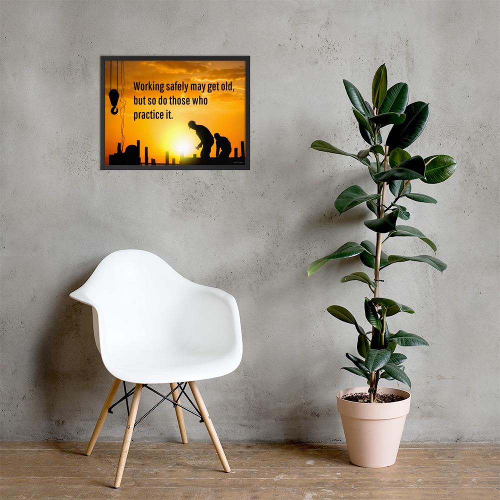 A workplace safety poster showing a construction site and construction workers being silhouetted by a bright and beautiful sunset of different shades of orange with the slogan working safely may get old, but so do those who practice it.