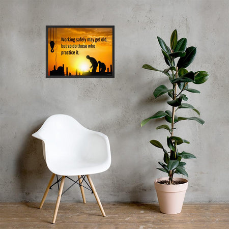 A workplace safety poster showing a construction site and construction workers being silhouetted by a bright and beautiful sunset of different shades of orange with the slogan working safely may get old, but so do those who practice it.