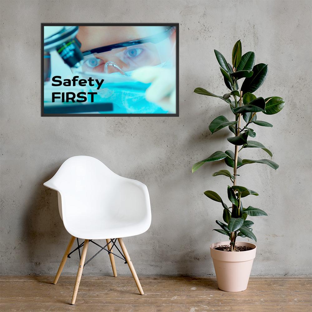 A safety poster showing a close up of a lab worker's eyes examining a sample on a microscope while wearing safety glasses and a mask with the slogan safety first in bold letters.