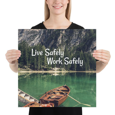 A workplace safety poster depicting a beautiful landscape of mountains in the background of a lake with a little wooden boat in the lake with text saying live safely work safely.