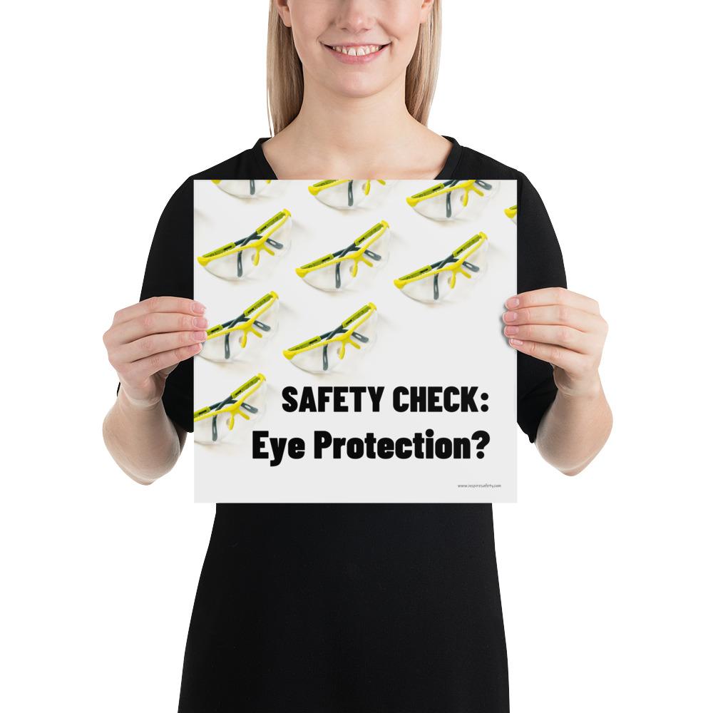An eye safety poster depicting many clear safety glasses with yellow trim neatly lined up in rows and rows with a safety slogan in the foreground.