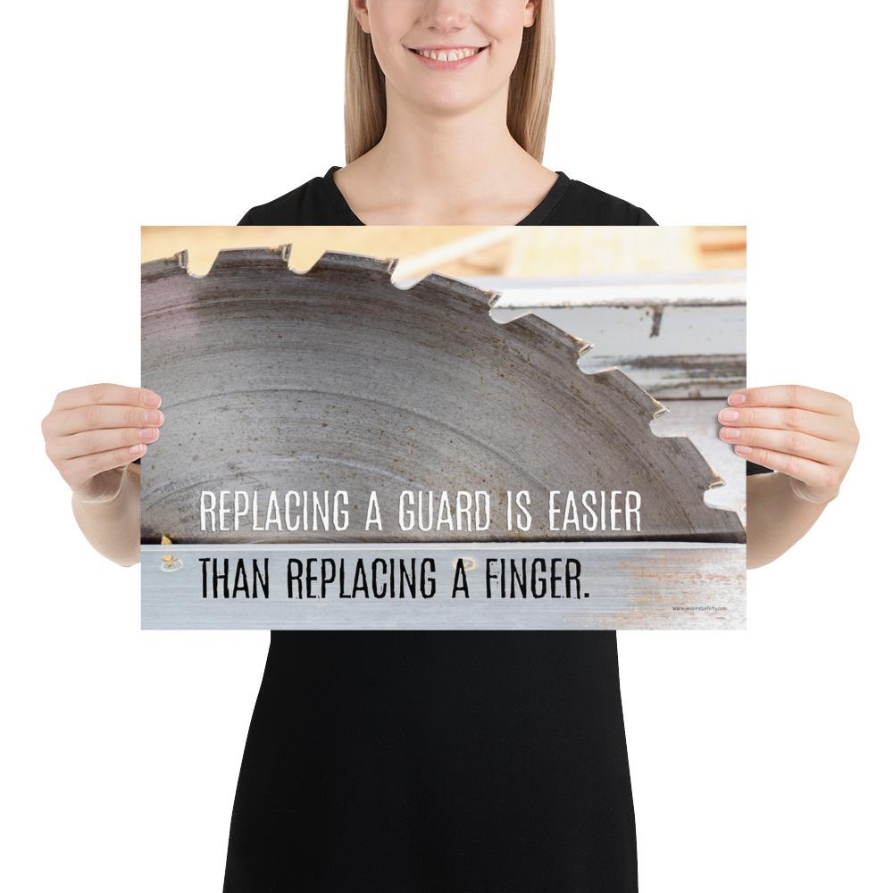 A workplace safety poster depicting a close up of a table saw blade in a workshop with a safety slogan on the bottom half of poster.