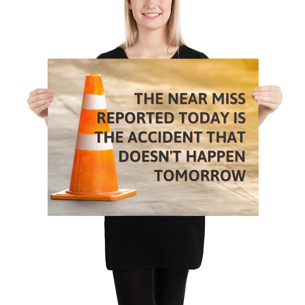 A workplace safety poster showing an orange safety cone with the slogan the near miss reported today is the accident that doesn't happen tomorrow.