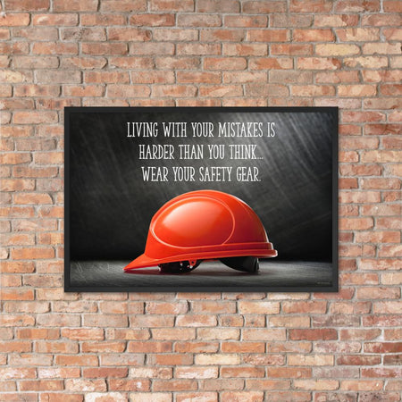 A workplace safety poster showing a bright red hard hat with an ominous black background with the slogan living with your mistakes is harder than you think, wear your safety gear.