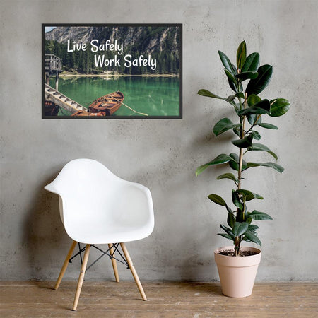A workplace safety poster depicting a beautiful landscape of mountains in the background of a lake with a little wooden boat in the lake with text saying live safely work safely.
