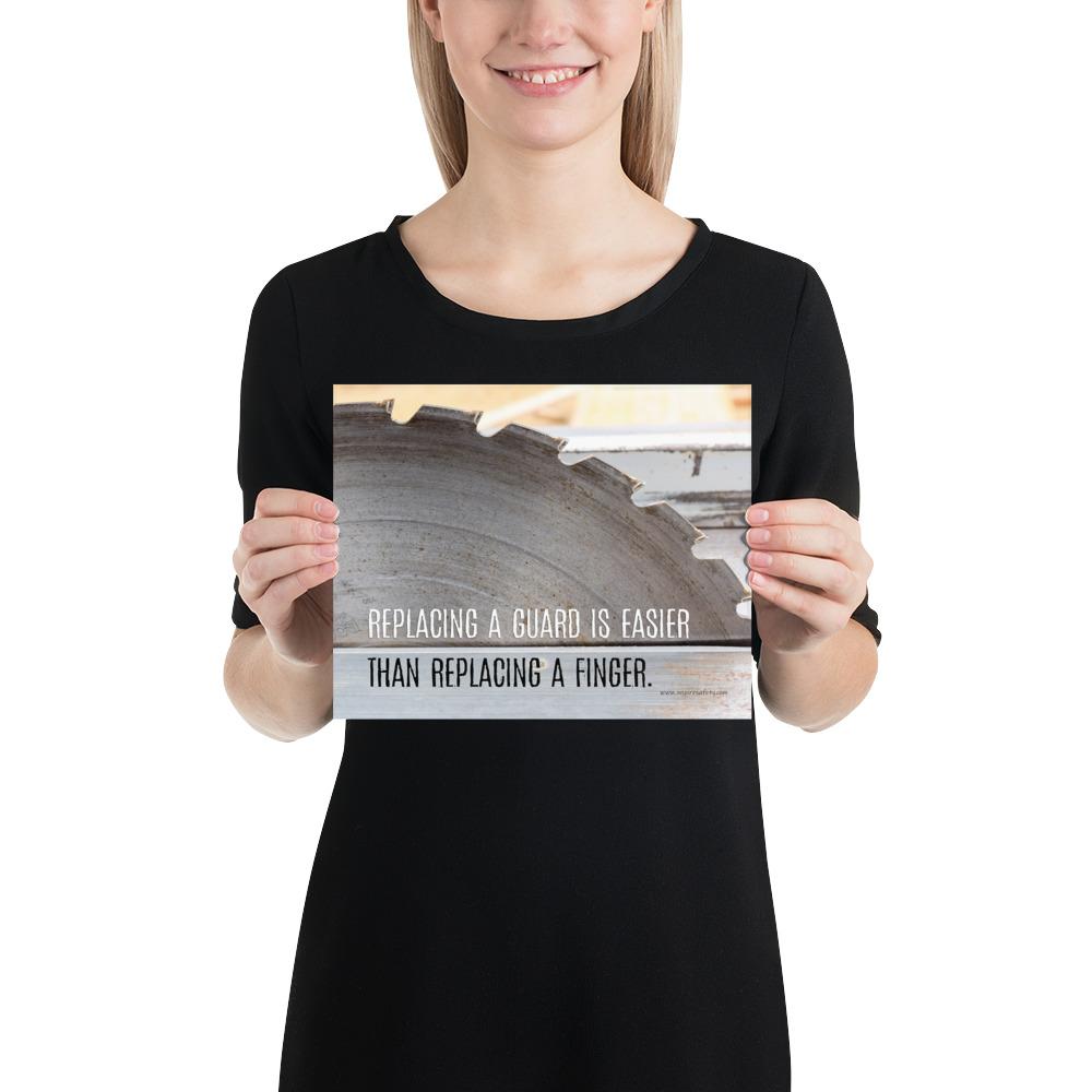 A workplace safety poster depicting a close up of a table saw blade in a workshop with a safety slogan on the bottom half of poster.