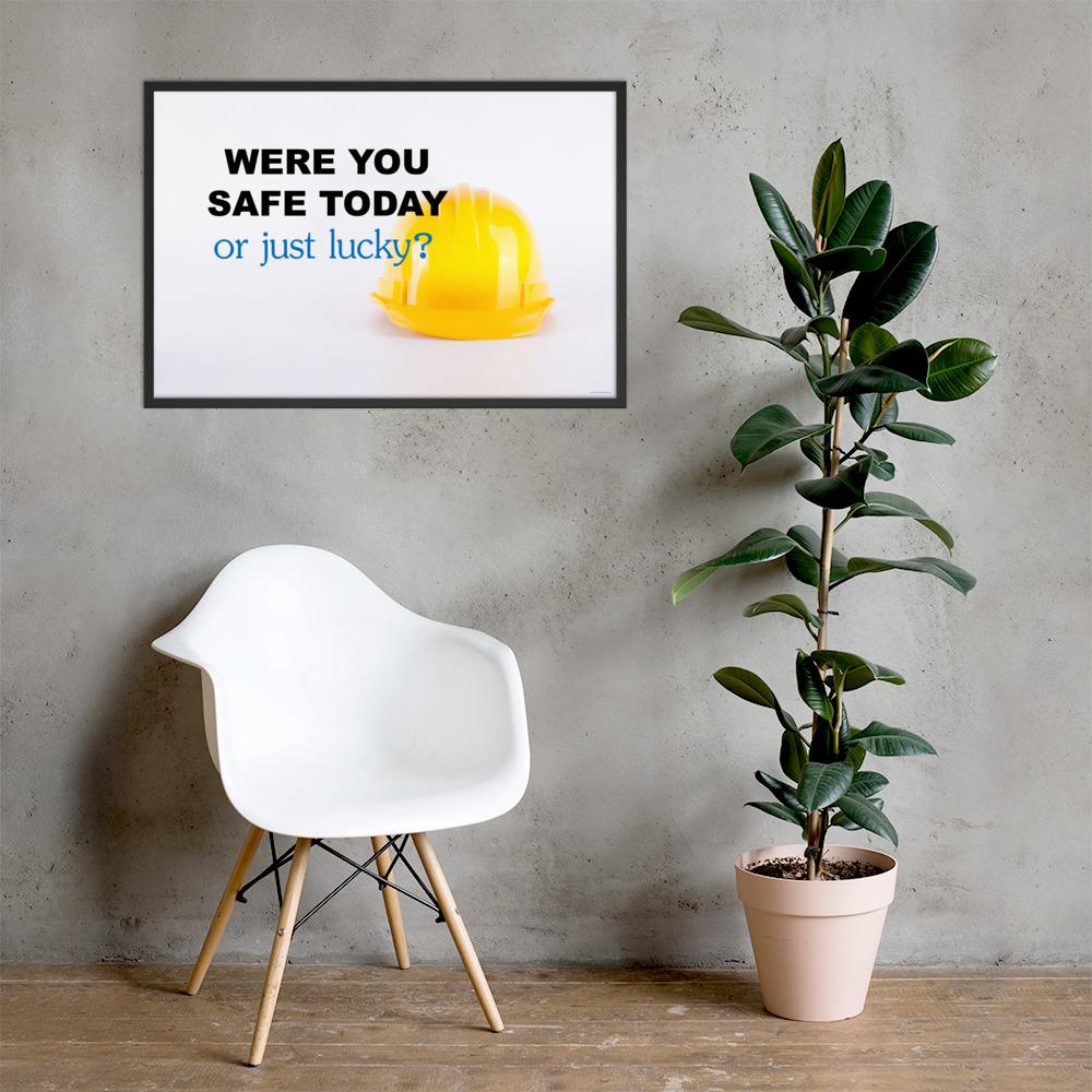 A workplace safety poster showing a yellow hard hat on a plain white background with the slogan were you safe today, or just lucky?