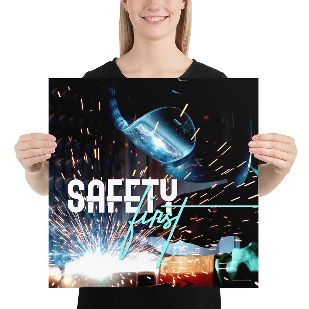 A safety poster showing a close-up of a welder welding a pipe while wearing a welding hood with bright sparks flying all around with the slogan safety first.
