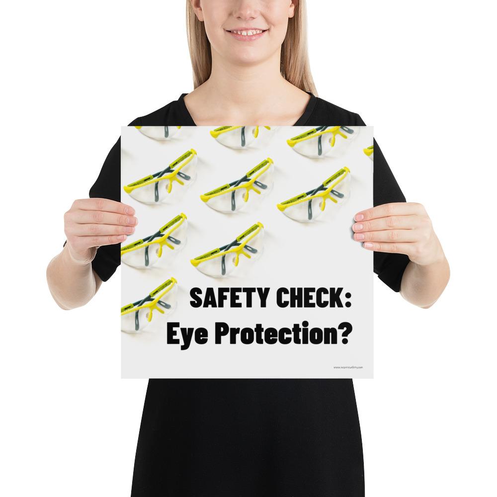 An eye safety poster depicting many clear safety glasses with yellow trim neatly lined up in rows and rows with a safety slogan in the foreground.