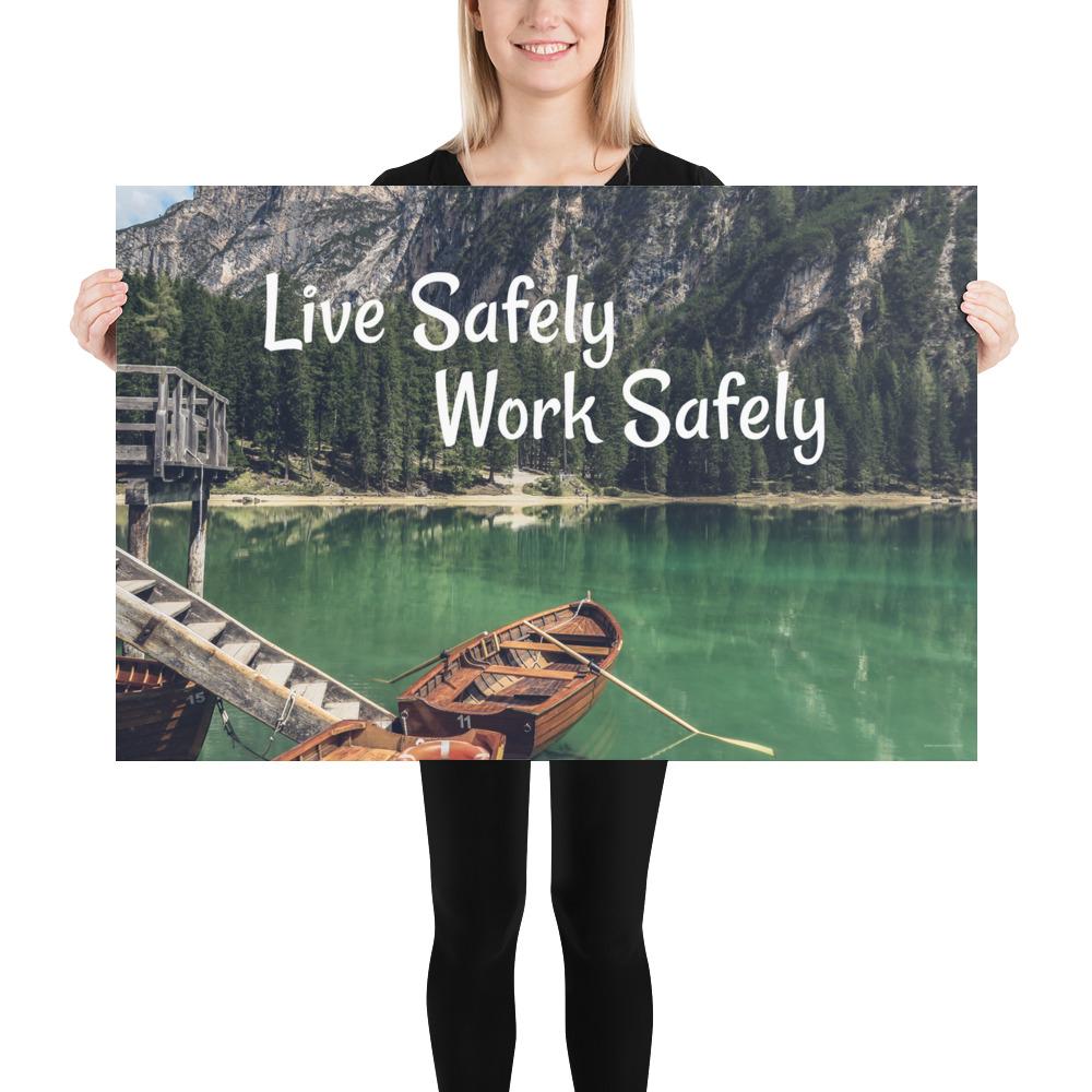 A workplace safety poster depicting a beautiful landscape of mountains in the background of a lake with a little wooden boat in the lake with text saying live safely work safely.
