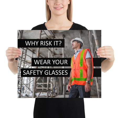 A safety poster showing a construction worker in a reflective orange vest, hard hat, and safety glasses on a construction site looking out with a safety slogan to the left.