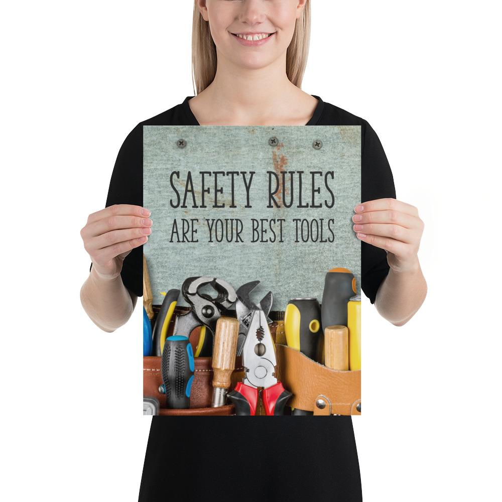 A safety poster showing various tools including screwdrivers, pliers, and wrenches laying on a worktable with the slogan safety rules are your best tools.