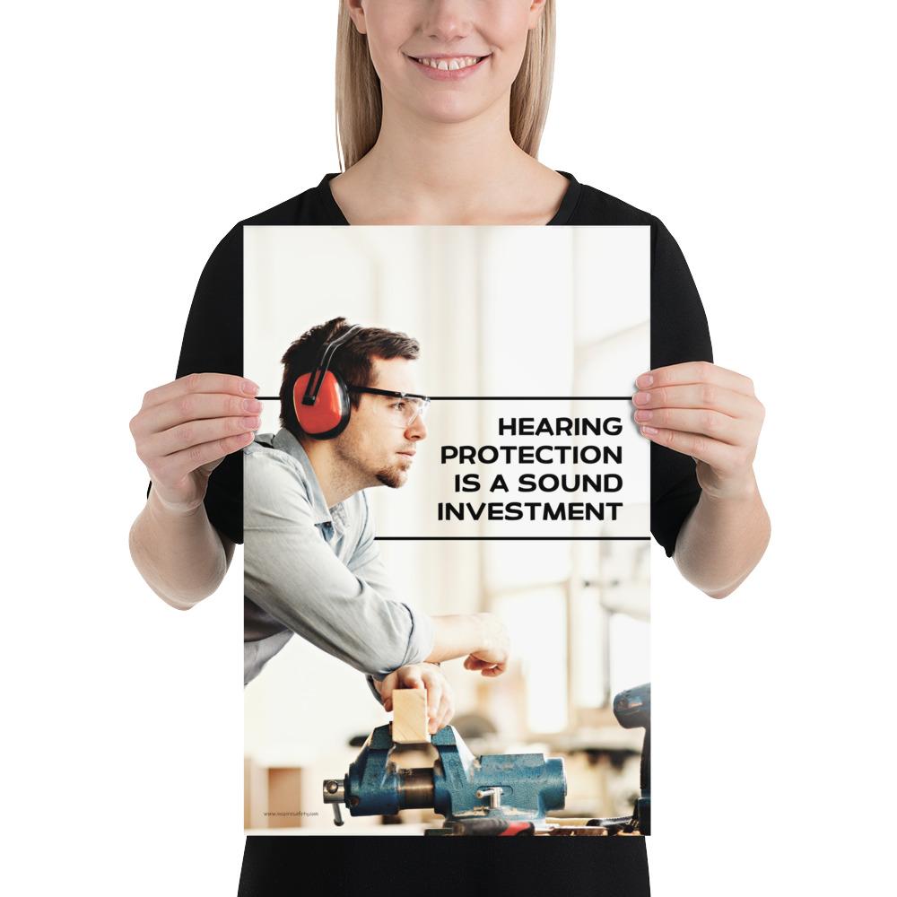 A workplace safety poster of a man in safety glasses and earmuffs taking a break in his woodshop with a safety slogan to the right.