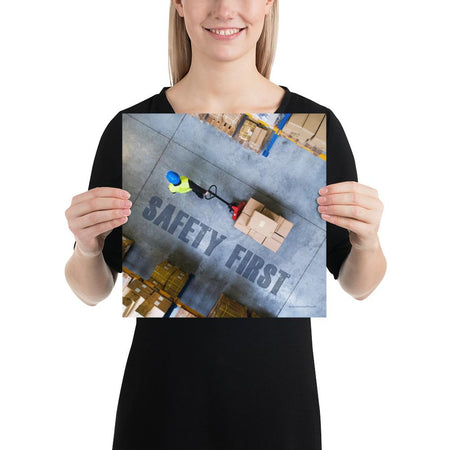 A safety poster showing a bird's-eye view of a worker in a warehouse pulling boxes on a pallet jack with the slogan safety first in bold letters.