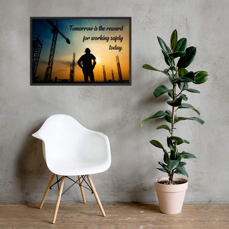 A safety poster showing a worker on a construction site being silhouetted by a sunset of orange and blue colors with the slogan tomorrow is the reward for working safely today.