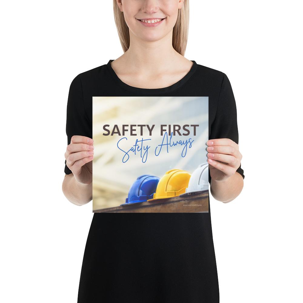 A workplace safety poster showing a white, a yellow, and a blue hardhat sitting on a wall with the slogan safety first, safety always.