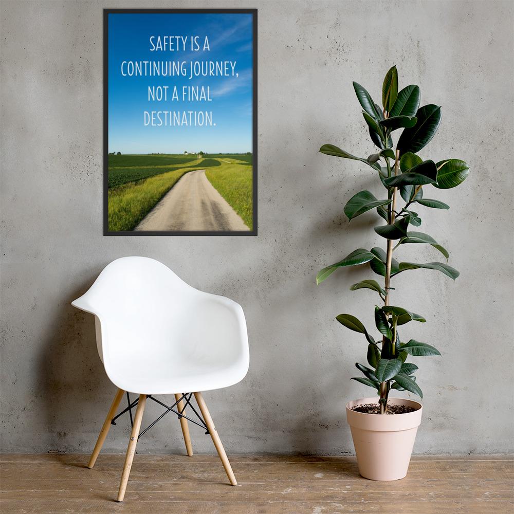 A workplace safety poster depicting a beautiful sunny day with a bright blue sky and a lush green field being cut down the middle by a dirt road leading off into the countryside with the text safety is a continuing journey, not a final destination.