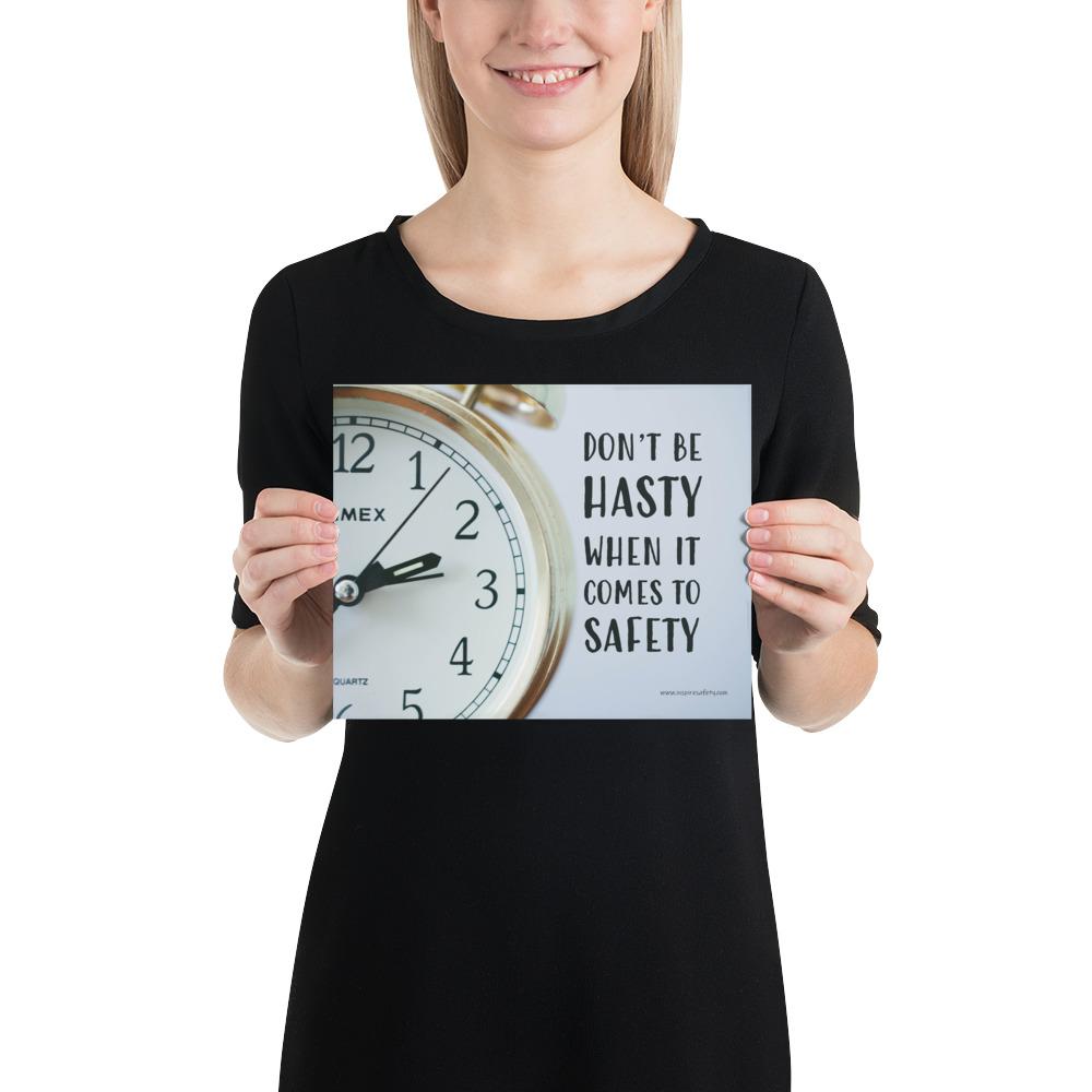 A workplace safety poster showing a close-up of a clock face with the slogan don't be hasty when it comes to safety.