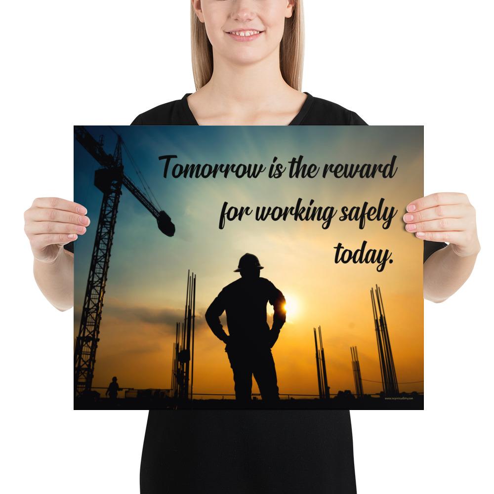 A safety poster showing a worker on a construction site being silhouetted by a sunset of orange and blue colors with the slogan tomorrow is the reward for working safely today.