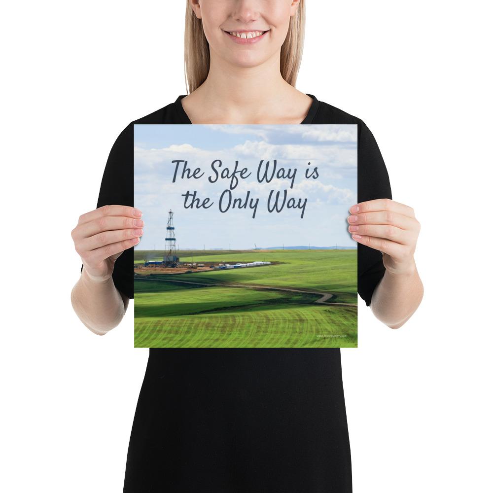 A safety poster showing an oil rig in a beautiful landscape scene of a field with vivid green grass and a bright blue sky with the slogan the safe way is the only way.