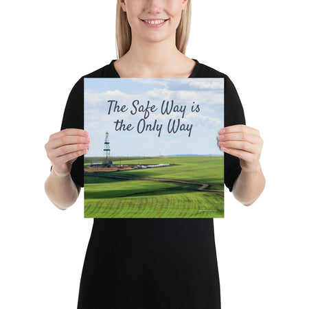 A safety poster showing an oil rig in a beautiful landscape scene of a field with vivid green grass and a bright blue sky with the slogan the safe way is the only way.