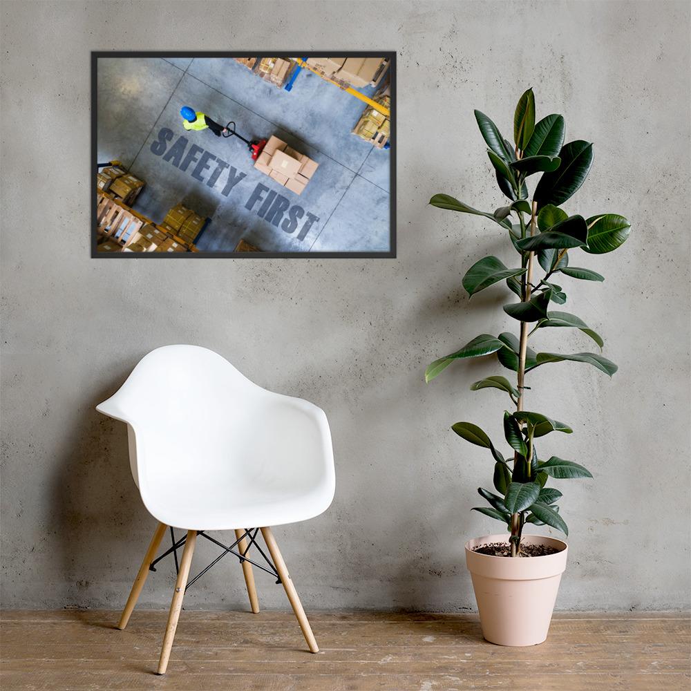 A safety poster showing a bird's-eye view of a worker in a warehouse pulling boxes on a pallet jack with the slogan safety first in bold letters.
