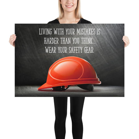 A workplace safety poster showing a bright red hard hat with an ominous black background with the slogan living with your mistakes is harder than you think, wear your safety gear.