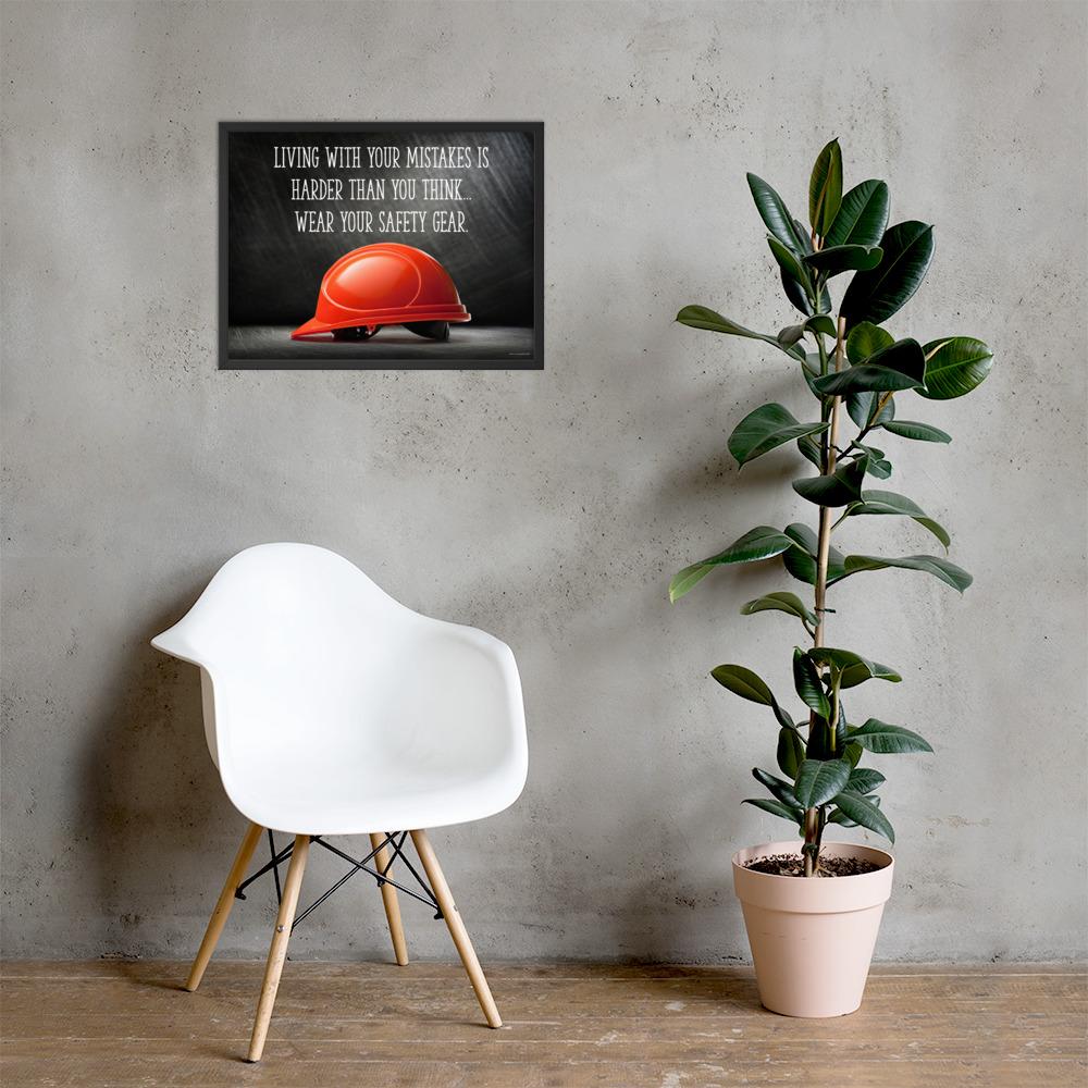 A workplace safety poster showing a bright red hard hat with an ominous black background with the slogan living with your mistakes is harder than you think, wear your safety gear.