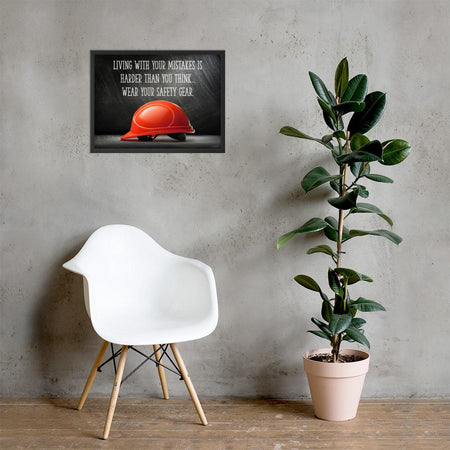 A workplace safety poster showing a bright red hard hat with an ominous black background with the slogan living with your mistakes is harder than you think, wear your safety gear.