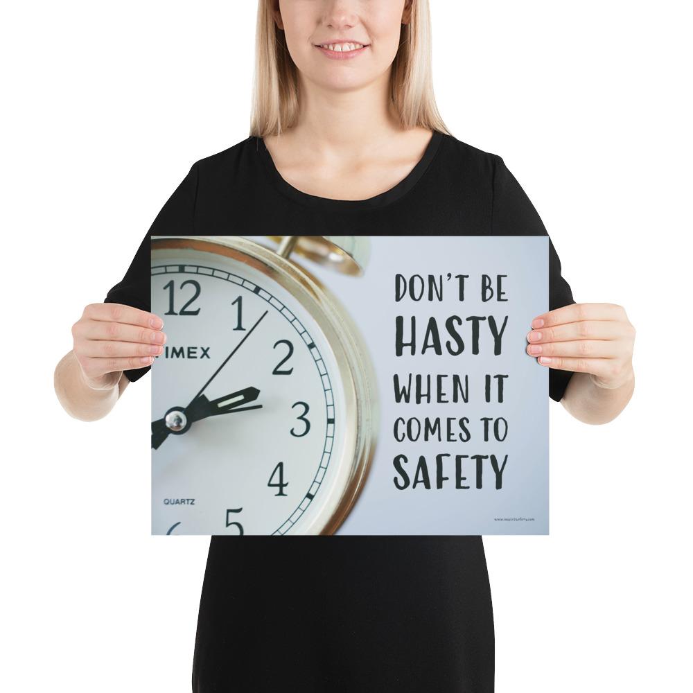 A workplace safety poster showing a close-up of a clock face with the slogan don't be hasty when it comes to safety.