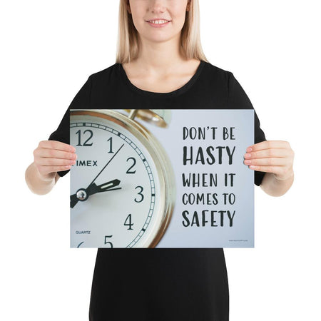 A workplace safety poster showing a close-up of a clock face with the slogan don't be hasty when it comes to safety.