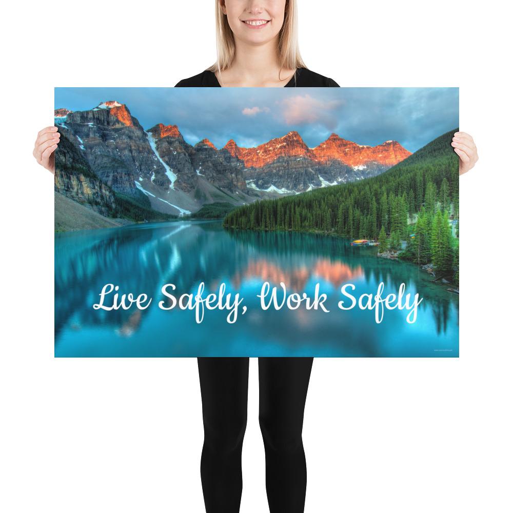 A workplace safety poster depicting a beautiful landscape of mountains with a river flowing down the side of the mountains into a bright blue pond with text saying live safely work safely.