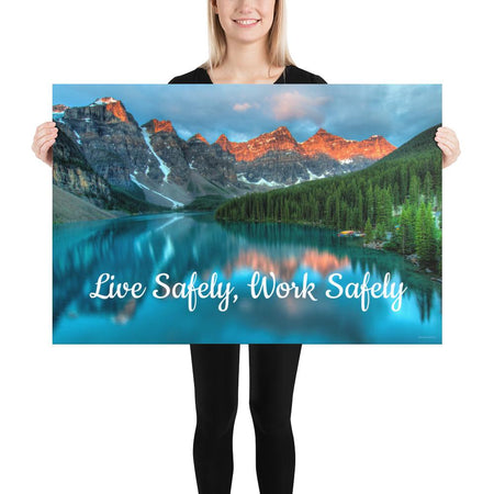 A workplace safety poster depicting a beautiful landscape of mountains with a river flowing down the side of the mountains into a bright blue pond with text saying live safely work safely.