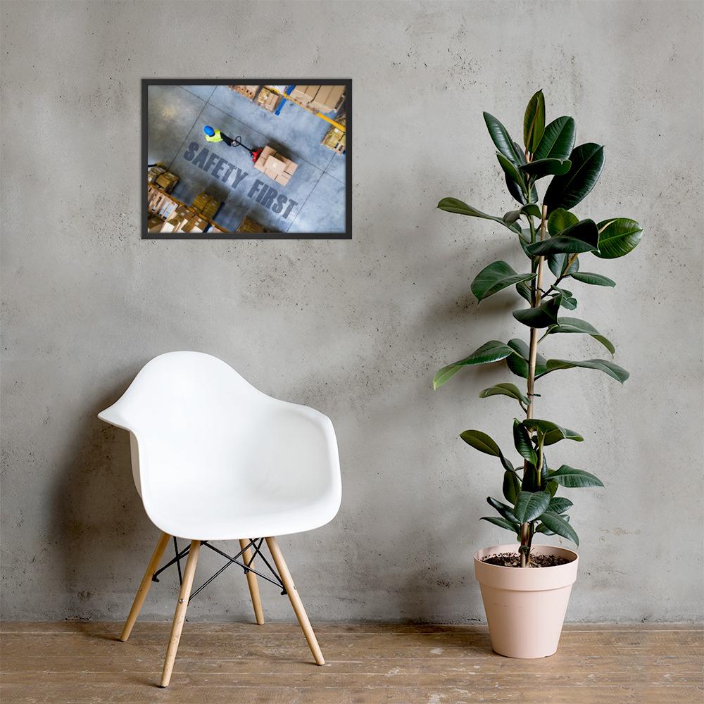 A safety poster showing a bird's-eye view of a worker in a warehouse pulling boxes on a pallet jack with the slogan safety first in bold letters.