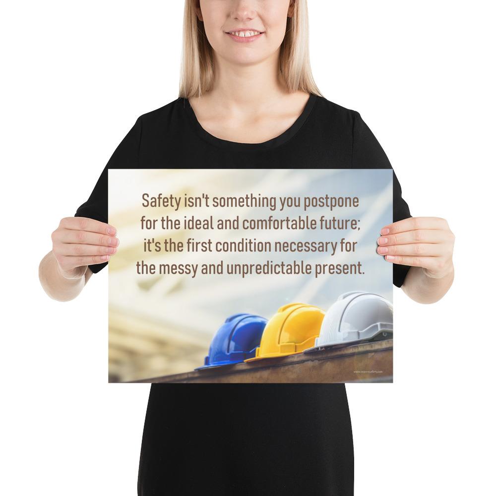 A workplace safety poster showing 3 multi colored hardhats sitting on a wall with the slogan safety isn't something you postpone for the ideal and comfortable future. It's the first condition necessary for the messy and unpredictable present.