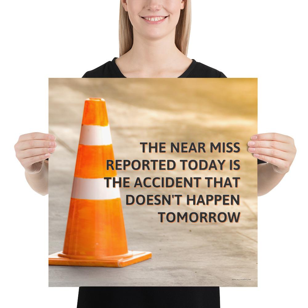 A workplace safety poster showing an orange safety cone with the slogan the near miss reported today is the accident that doesn't happen tomorrow.