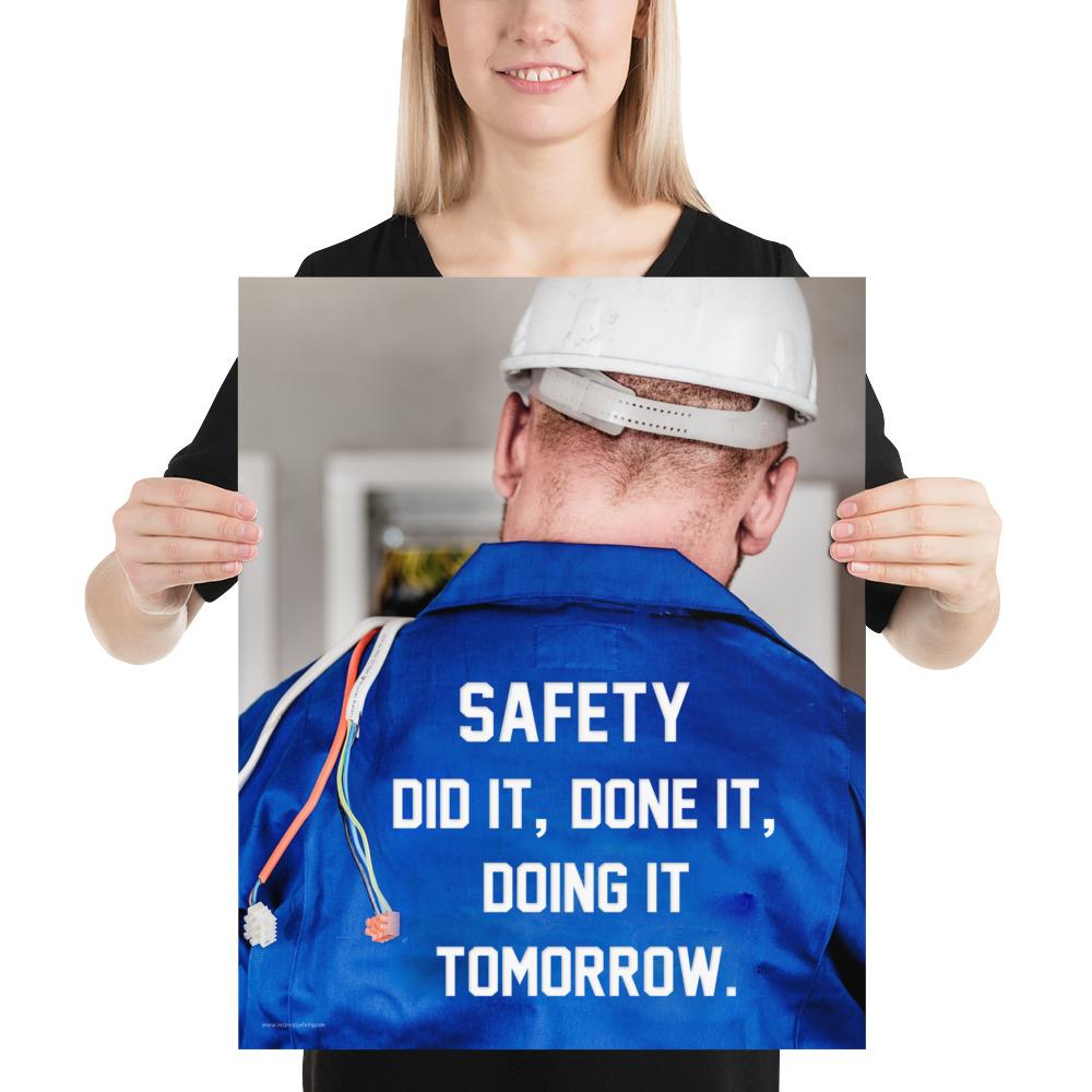 Safety poster showing an electrician wearing a hard hat and holding cables working on an electrical panel with text on the back of his bright blue shirt.