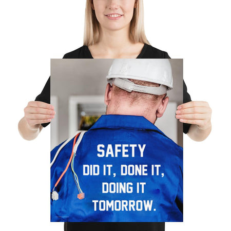 Safety poster showing an electrician wearing a hard hat and holding cables working on an electrical panel with text on the back of his bright blue shirt.