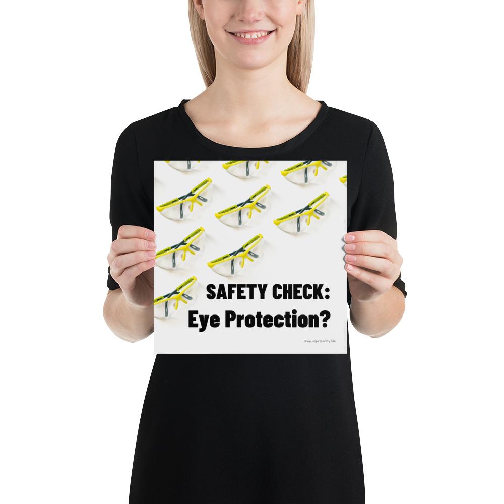 An eye safety poster depicting many clear safety glasses with yellow trim neatly lined up in rows and rows with a safety slogan in the foreground.