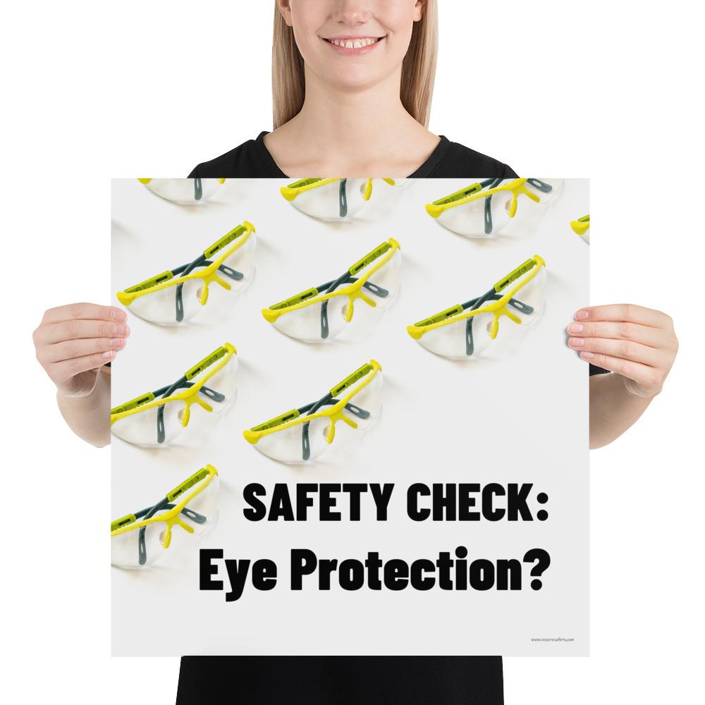 An eye safety poster depicting many clear safety glasses with yellow trim neatly lined up in rows and rows with a safety slogan in the foreground.