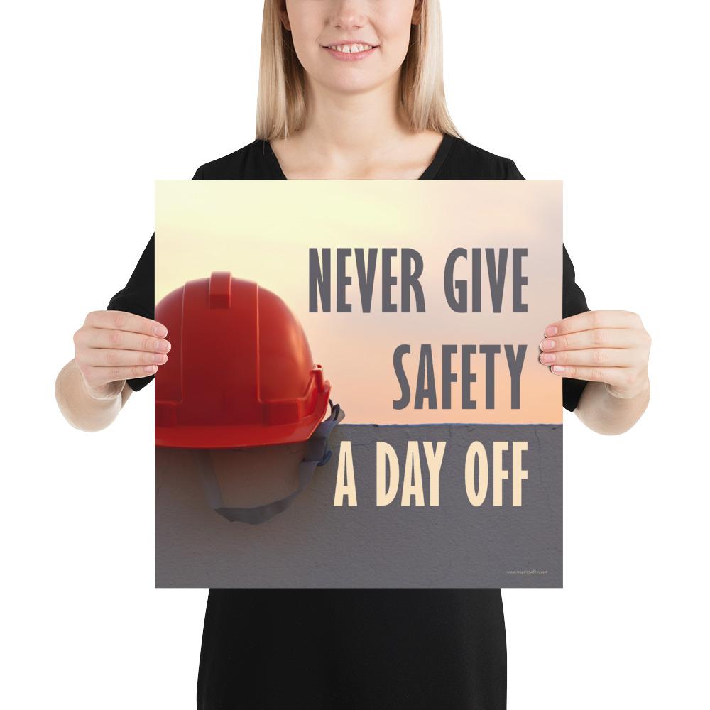 A workplace safety poster depicting a red hard hat sitting on a concrete wall with a dreamy pink sunset in the background with the text never give safety a day off to the right.