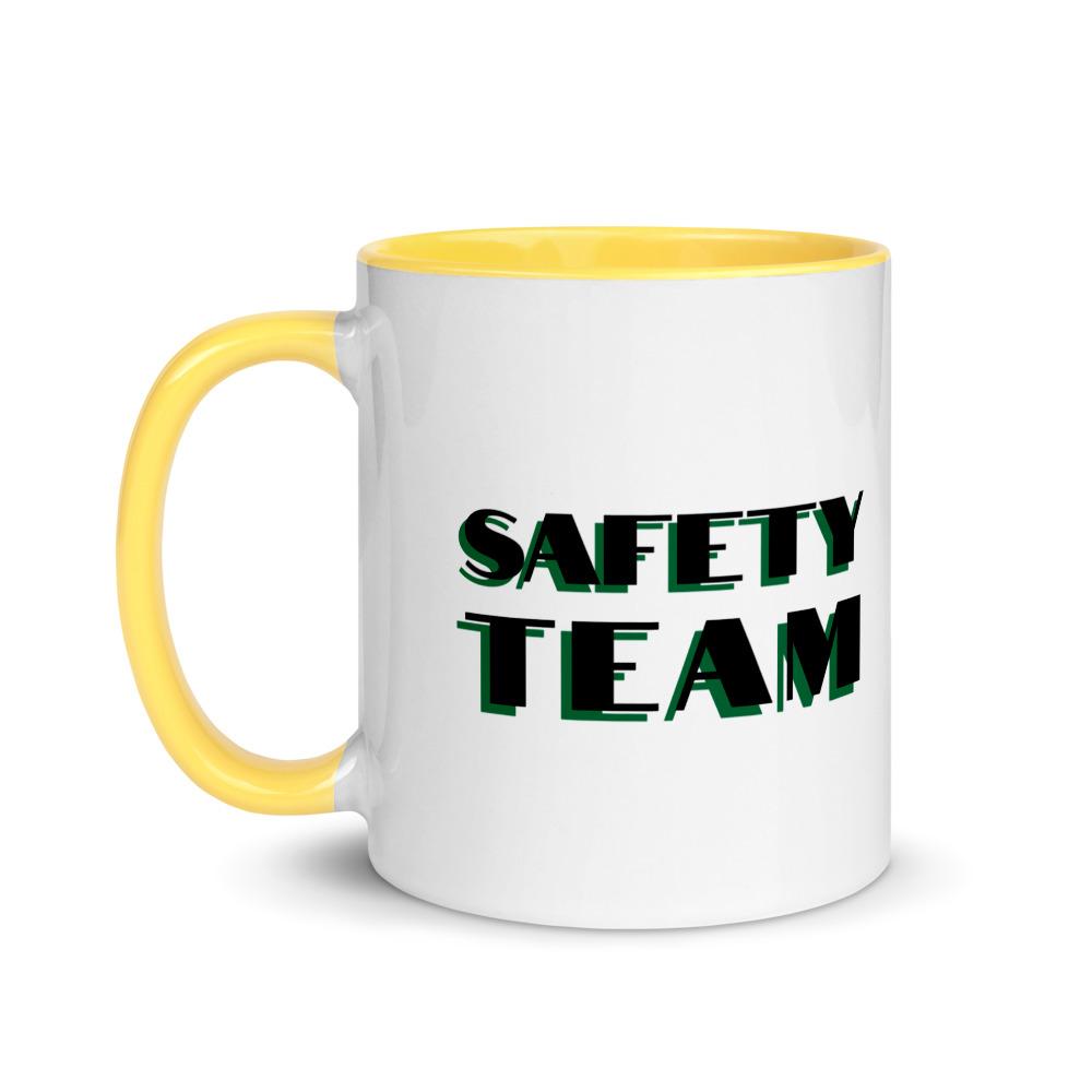White ceramic mug with "Safety Team" in bold text across the side, with yellow color on the inside, the rim, and the handle.
