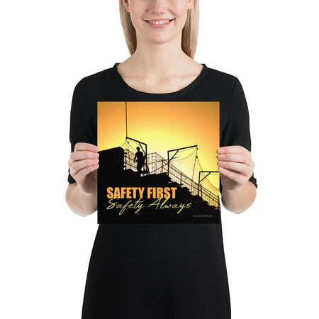 A workplace safety poster showing a construction site and construction workers being silhouetted by a bright and beautiful sunset of different shades of orange with the slogan safety first, safety always.