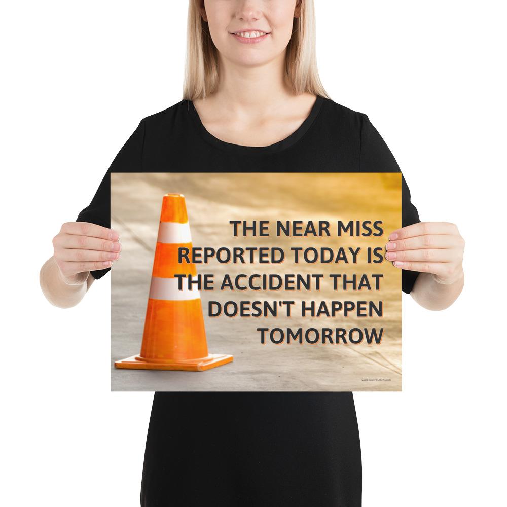 A workplace safety poster showing an orange safety cone with the slogan the near miss reported today is the accident that doesn't happen tomorrow.