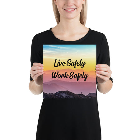 A safety poster showing a mountain range with a beautiful gradient in the sky of blue, yellow, and pink with the safety slogan "Live Safely Work Safely."