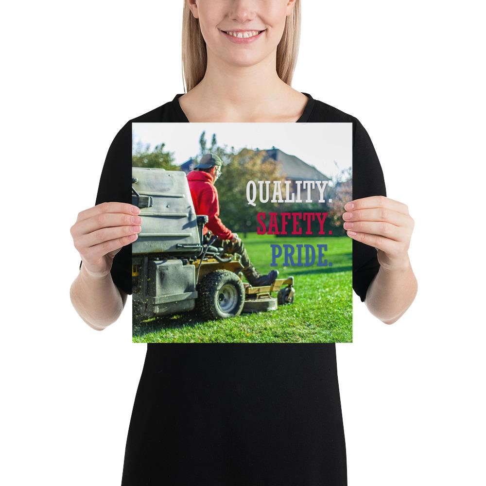 A workplace safety poster showing a man mowing a lawn on a sitting mower with the words quality, safety, pride in white, red, and blue, respectively.