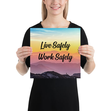 A safety poster showing a mountain range with a beautiful gradient in the sky of blue, yellow, and pink with the safety slogan "Live Safely Work Safely."