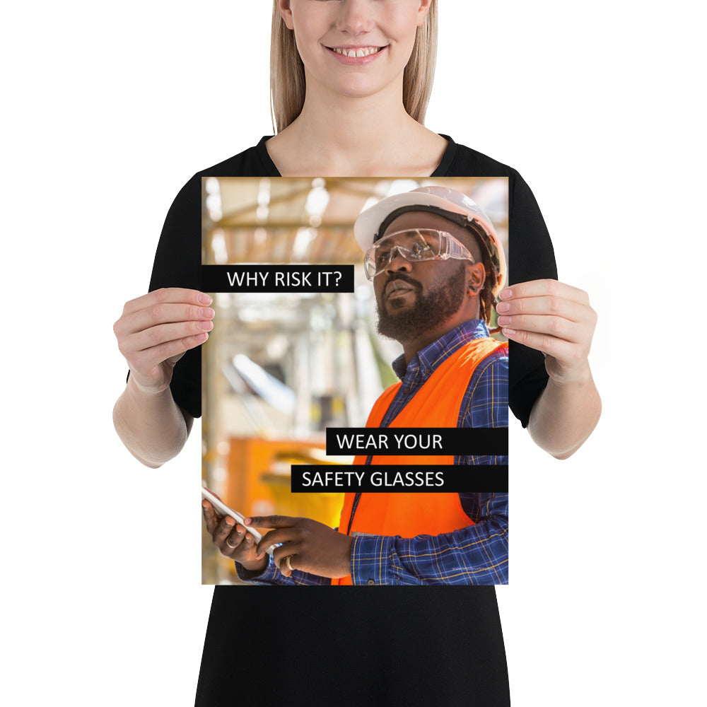 A safety poster showing a man in a reflective vest, hard hat, and safety glasses working with the slogan "Why risk it? Wear your safety glasses."
