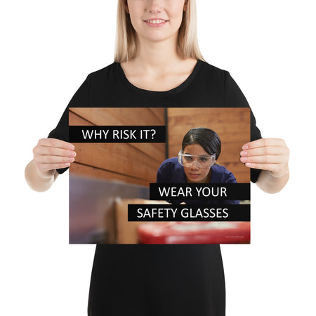 A safety poster showing a woman using a table saw to cut wood wearing safety glasses with the slogan "Why Risk It? Wear Your Safety Glasses."