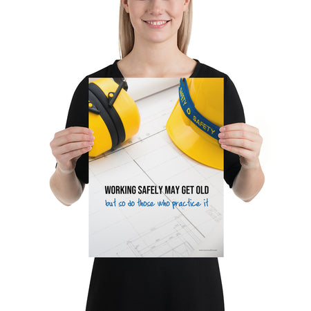 A construction safety poster showing yellow ear muffs and a hard hat resting on blueprints with the slogan "Working safely may get old, but so do those who practice it."